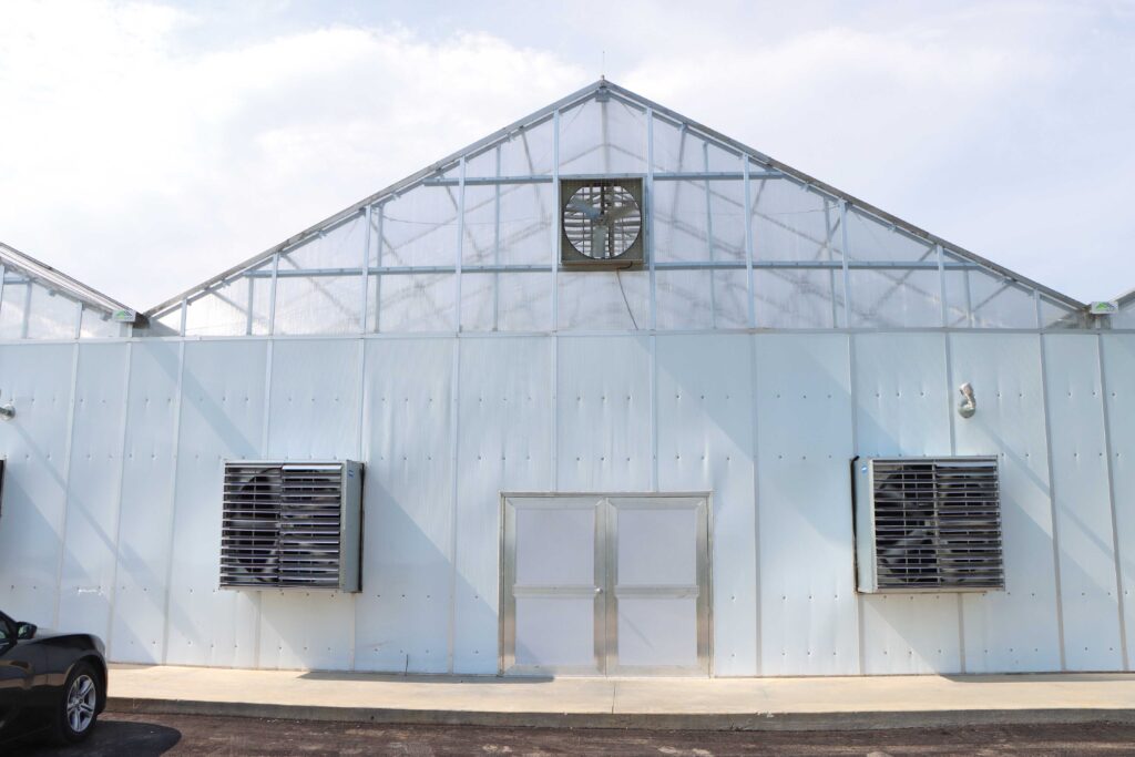 End wall of peaked roof greenhouse with exhaust fans