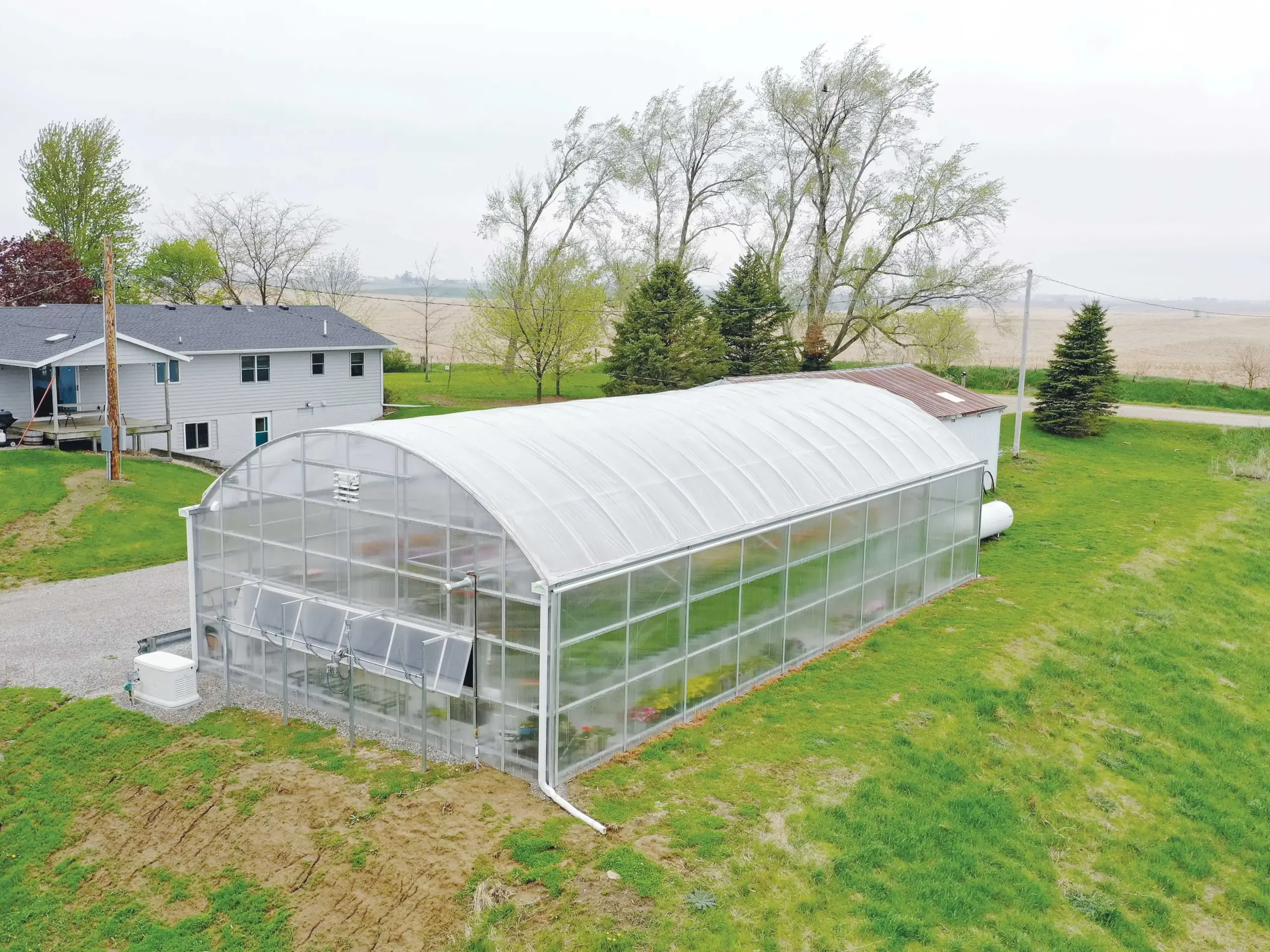 free-standing greenhouse with a round-style roof