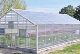 Exterior aerial view of a GrowSpan Series 2000 Greenhouse at a high school