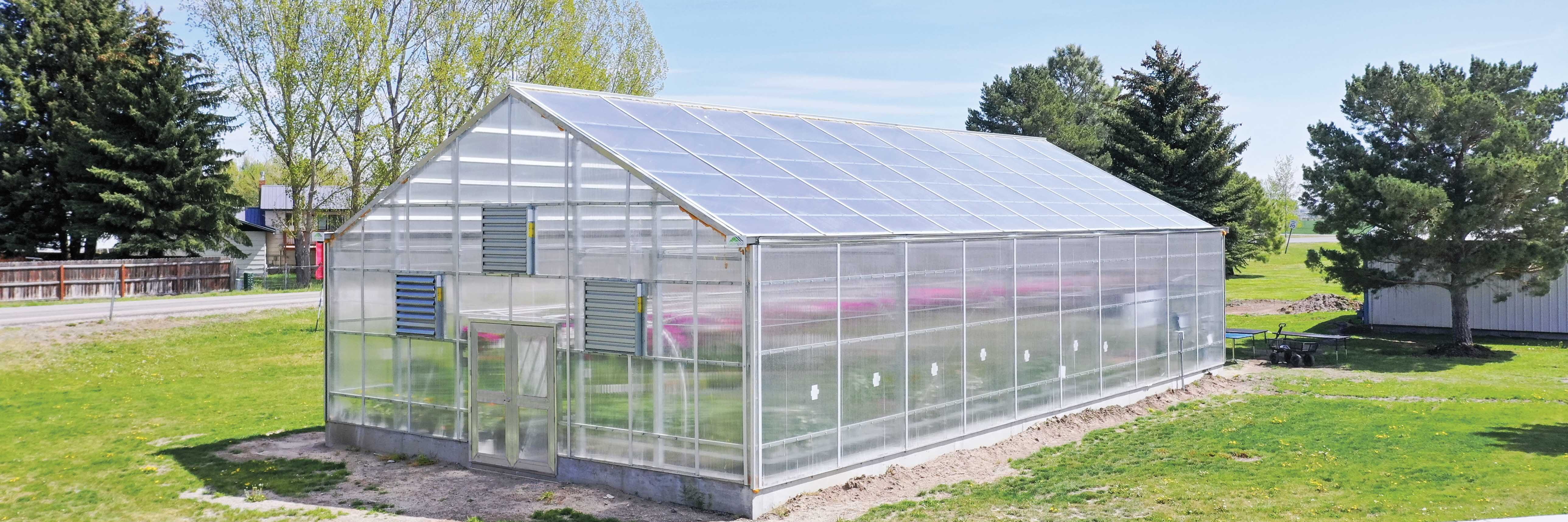 Exterior aerial view of a GrowSpan Series 2000 Greenhouse at a high school